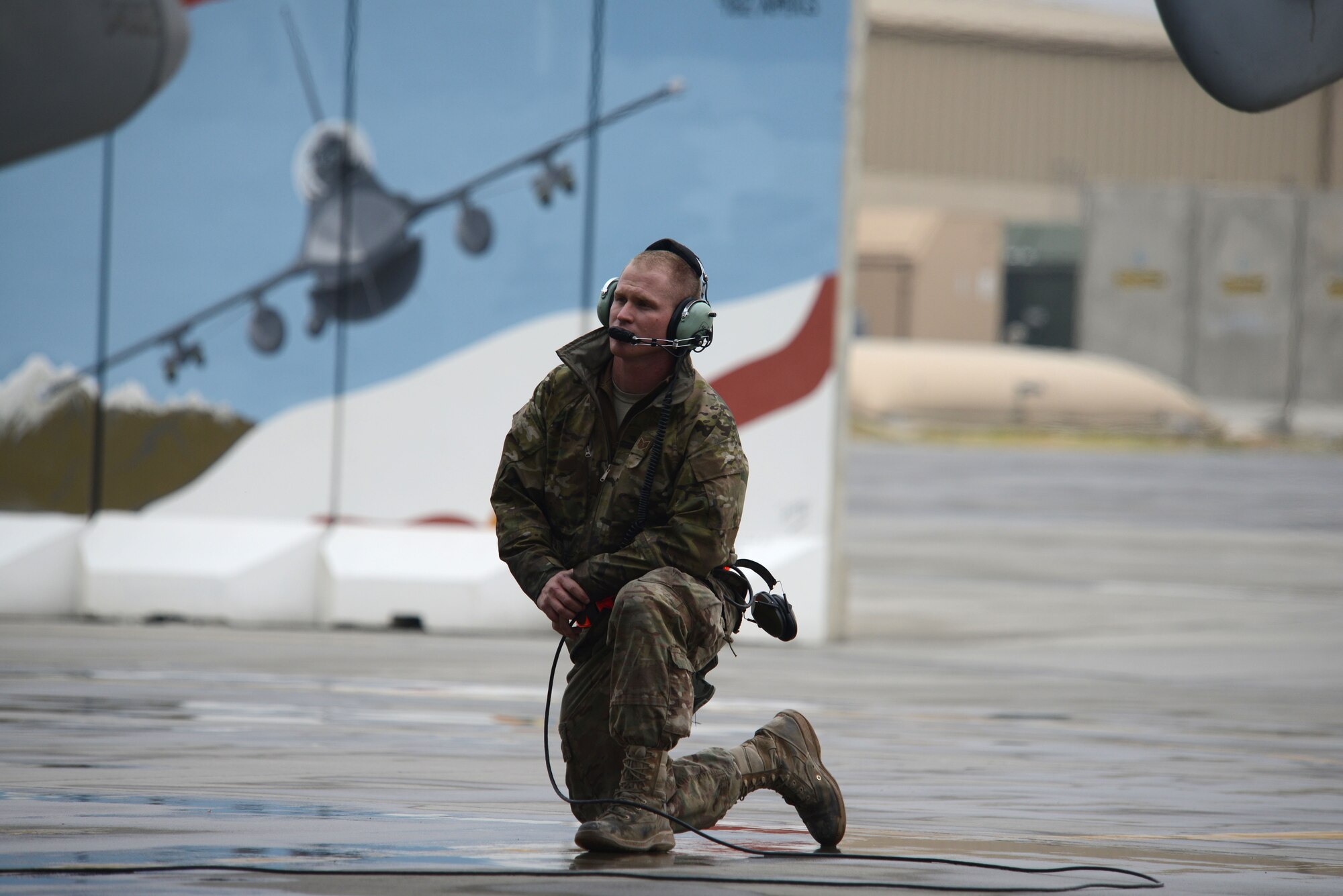 BAGRAM AIRFIELD, Afghanistan -  U.S. Air Force Tech. Sgt. Dereck Finken, an A-10 Thunderbolt II crew chief assigned to the 455th Expeditionary Maintenance Squadron, waits for Lt. Col Bryan Stone, 303rd Expeditionary Fighter Squadron commander, to complete his operation checks before departing Bagram Airfield, Afghanistan Oct. 19, 2014. Finken, deployed from Whiteman Air Force Base, Mo., is responsible for ensuring the A-10 is mission ready and able to perform close air support missions throughout Afghanistan in support of Operation Enduring Freedom. (U.S. Air Force photo by Master Sgt. Cohen A. Young/Released)