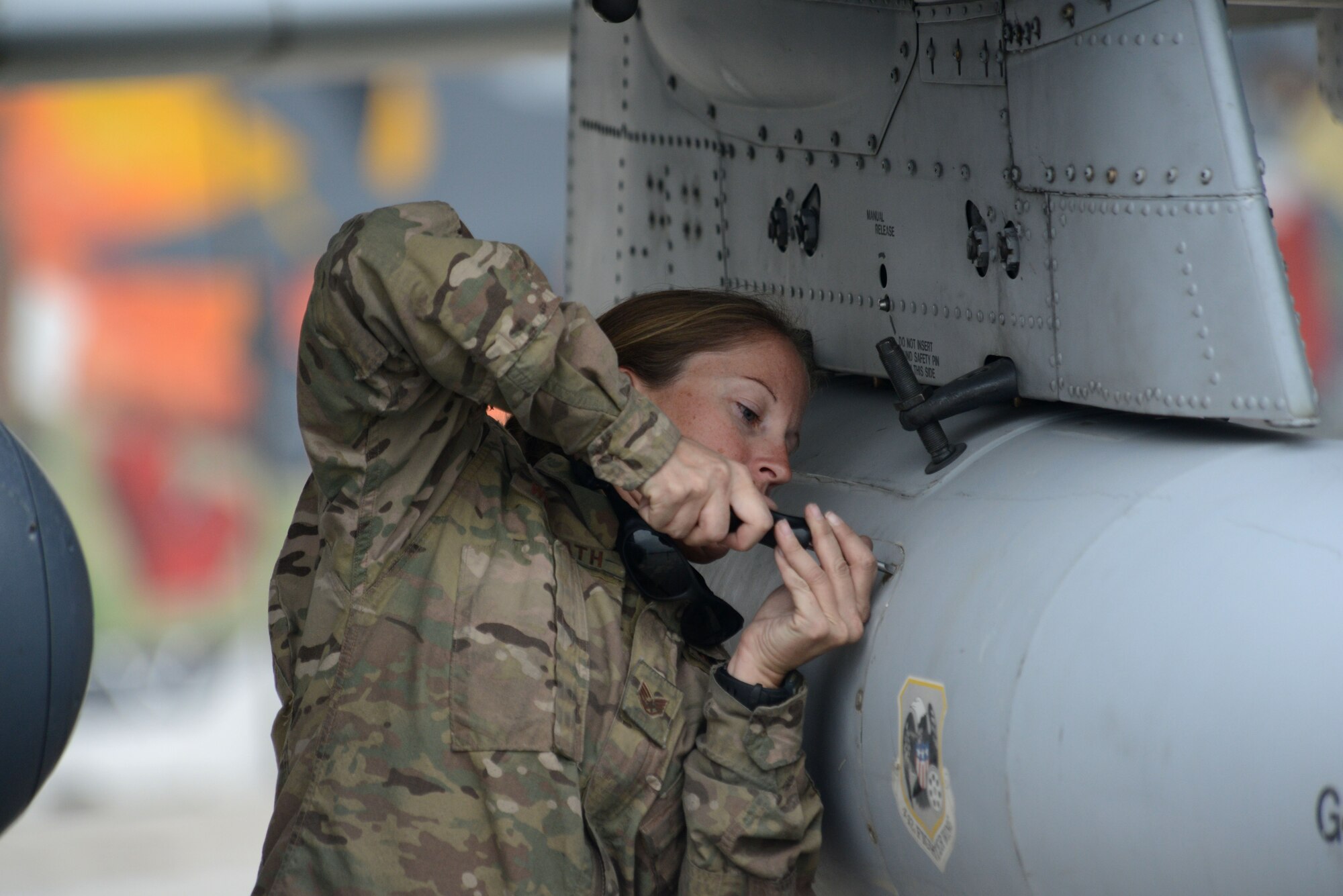 BAGRAM AIRFIELD, Afghanistan -  U.S. Air Force Staff Sgt. Jessica Womrath, a crew chief assigned to the 455th Expeditionary Maintenance Squadron, tightens a bolt on the fuel pod of an A-10 Thunderbolt II Oct. 19, 2014 at Bagram Airfield, Afghanistan. Womrath, a native of Kansas City, Mo., is responsible for ensuring the aircraft is mission ready and able to perform close air support missions throughout Afghanistan. Womrath is deployed form the 442nd Fighter Wing at Whiteman Air Force Base, Mo. (U.S. Air Force photo by Master Sgt. Cohen A. Young/Released)