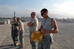 Senior Airman Kristopher P. Stewart, an engineering assistant with the Kansas Air National Guard's 190th Air Refueling Wing, rolls a tape measure while working with other members of the Air Force to survey the Port- au-Prince airport. Stewart is one of 46 members of the unit, who deployed to Haiti to build support infrastructure, including an Expeditionary Medical Support (EMEDS) support hospital.