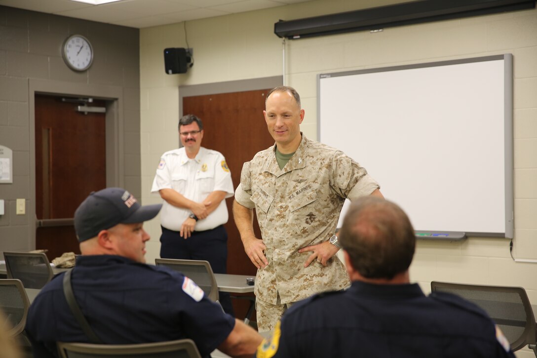 Col. Chris Pappas talks with a group of personnel from Cherry Point’s Fire and Emergency Services Department at Marine Corps Air Station Cherry Point, N.C., Oct. 15, 2014. The station Fire and Emergency Services Department earned the Marine Corps Small Fire Department of the Year Award for 2013. Pappas is the commanding officer of the air station.