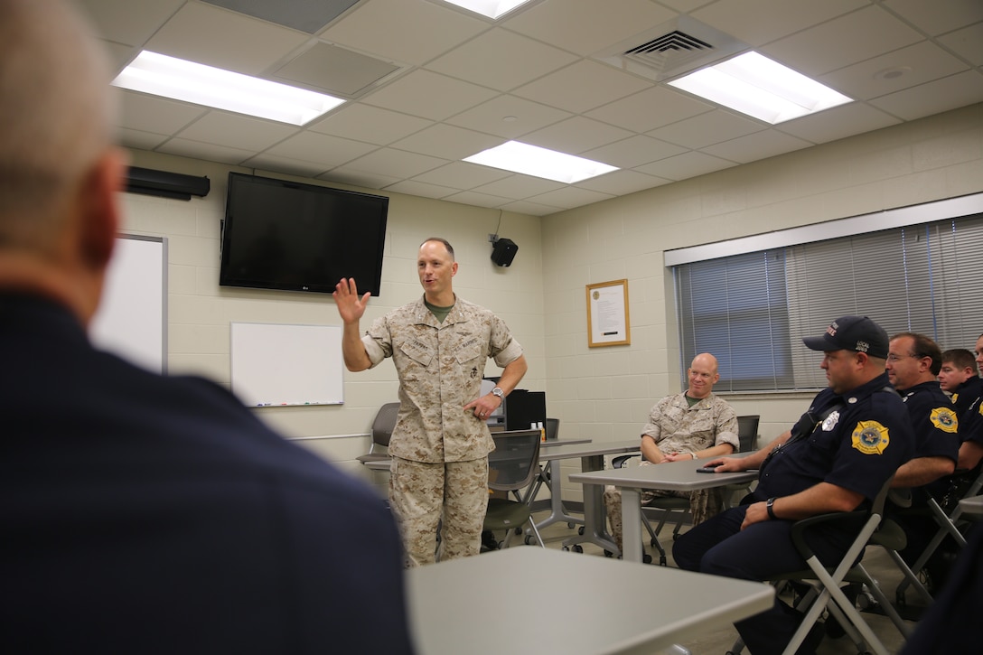 Col. Chris Pappas talks with a group of personnel from Cherry Point’s Fire and Emergency Services Department at Marine Corps Air Station Cherry Point, N.C., Oct. 15, 2014. The department earned the Marine Corps Small Fire Department of the Year Award for 2013. Pappas is the commanding officer of the air station.