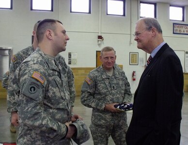 Sgt. Joseph Costley of the Missouri National Guard talks with Rep. Ike Skelton following a flag presentation the congressman made to the 311th Aviation Support Battalion, while 1st Sgt. James Forst listens in.