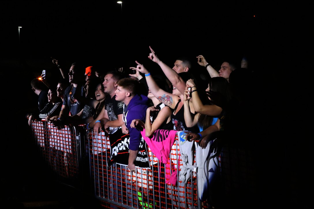 Marines, Sailors and their families throw their arms up during a free concert featuring the band Sevendust at Marine Corps Air Station Cherry Point, N.C., Oct. 16, 2014. The concert was a part of Marine Corps Community Services’ Rocktoberfest.