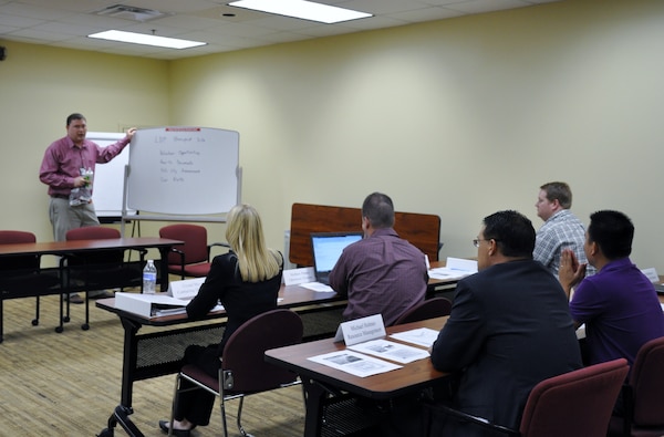 Members of the Louisville District Leadership Development Program discuss the new internal Sharepoint site for promoting volunteerism among the workforce.