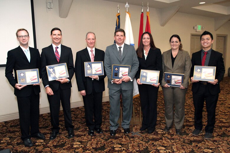 The participants of the U.S. Army Corps of Engineers South Pacific Division fiscal year 2014 Regional Leadership Development Program; Ondrea Hummel, Hunter Merritt, Derek Morley, Beth Salyers, Jacob Hensel, Rueben Saski and Jim Mazza, gather for a photo after their graduation ceremony at Fort MacArthur Oct. 21.