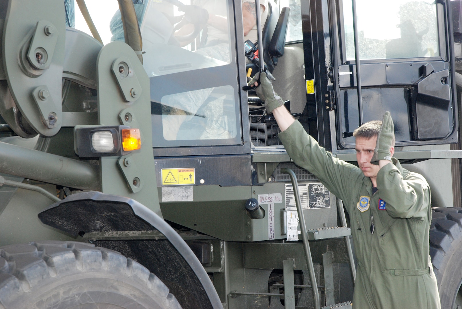 Chief Master Sgt. Todd Hunt, a 35th Expeditionary Airlift Squadron loadmaster, directs the loading of cargo by a forklift Jan. 22, 2010, at Homestead Air Reserve Base, Fla. Homestead served as an airlift hub for Operation Unified Response. The chief worked side-by-side with reservists, active-duty Airmen and other Guardsmen loading cargo on an Ohio Air National Guard C-130 Hercules in support of the earthquake victims in Haiti. Chief Hunt is assigned to the Ohio Air National Guard's 179th Airlift Wing at Mansfield, Ohio.