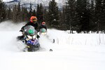 Warrant Officer Rick Fleming, left, and Staff Sgt. Elaine Jackson cut through the fresh powder Feb. 16, 2010 in preparation for the 2010 Alaska National Guard Iron Dog.