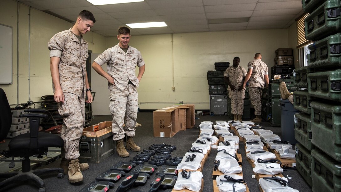 U.S. Marine Sgt. Michael Clifton, right, checks on his Marines aboard Camp Pendleton Calif., Oct. 20, 2014. Clifton, 24, from Galveston, Texas, is an AN/TRC-170 technician with the 15th Marine Expeditionary Unit aboard Camp Pendleton, Calif. (U.S. Marine Corps photo by Sgt. Emmanuel Ramos/Released)