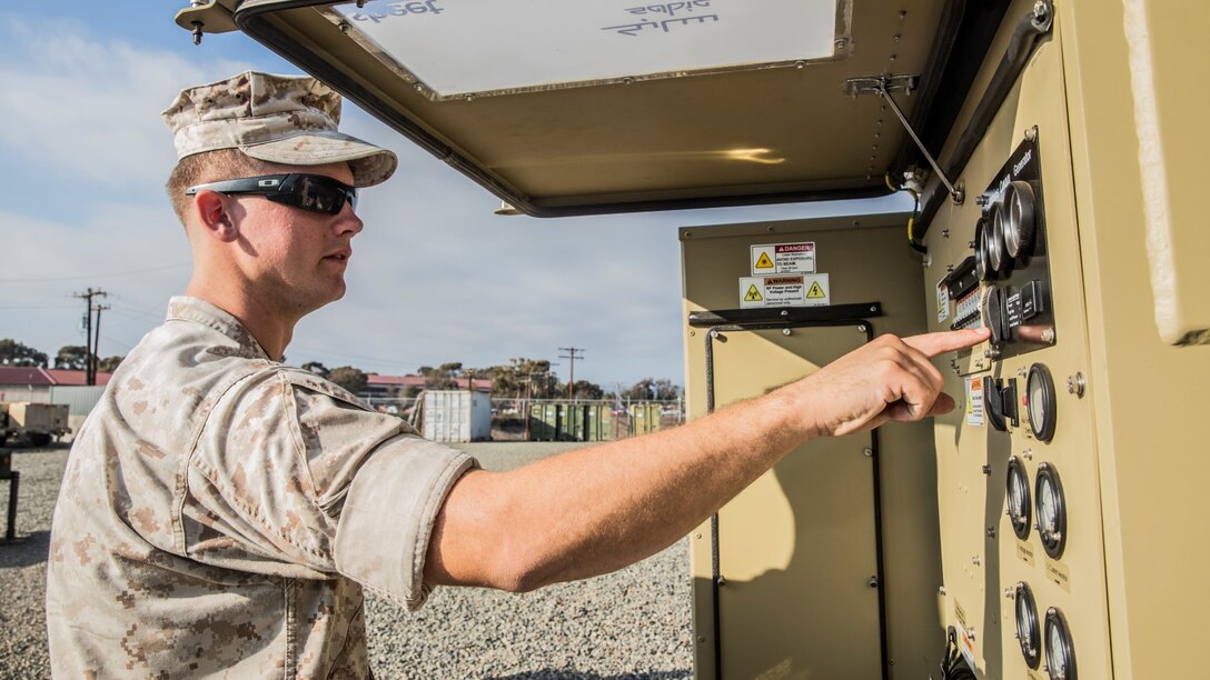 U.S. Marine Sgt. Michael Clifton inspects a Very Small Aperture Terminal-Large system aboard Camp Pendleton Calif., Oct. 20, 2014. Clifton, 24, from Galveston, Texas, is an AN/TRC-170 technician with the 15th Marine Expeditionary Unit aboard Camp Pendleton, Calif. (U.S. Marine Corps photo by Sgt. Emmanuel Ramos/Released)