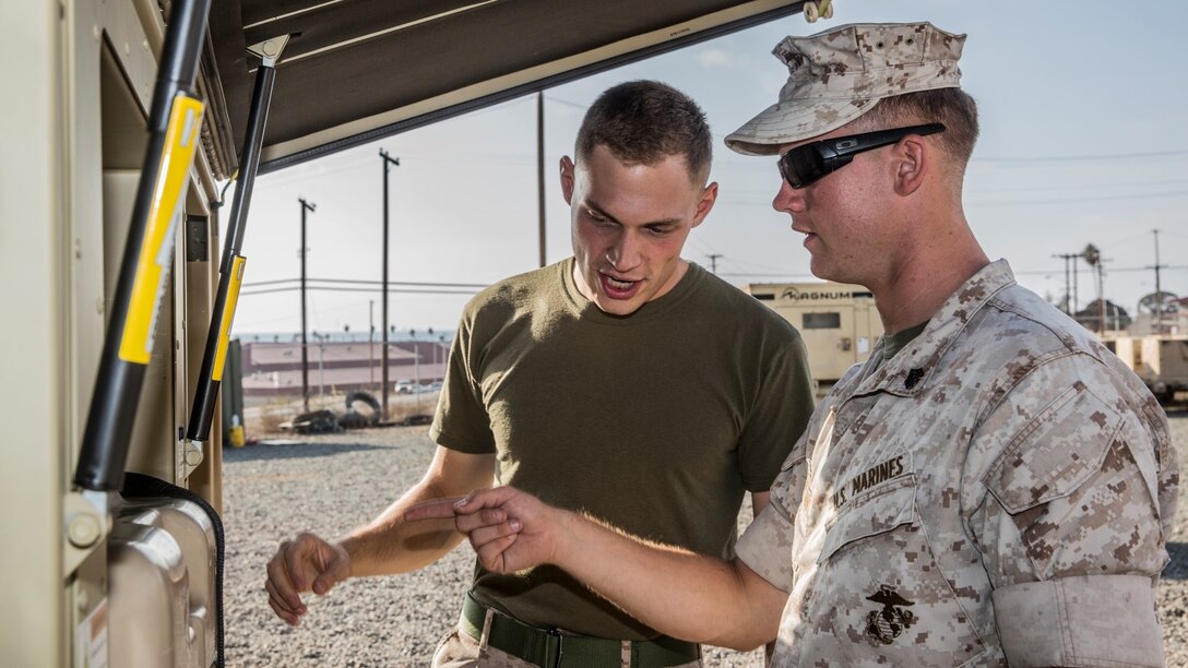 U.S. Marine Sgt. Michael Clifton, right, instructs Cpl. Taylor Bukoski on how to operate a Very Small Aperture Terminal-Large system aboard Camp Pendleton Calif., Oct. 20, 2014. Clifton, 24, from Galveston, Texas, is an AN/TRC-170 technician with the 15th Marine Expeditionary Unit aboard Camp Pendleton, Calif. (U.S. Marine Corps photo by Sgt. Emmanuel Ramos/Released)