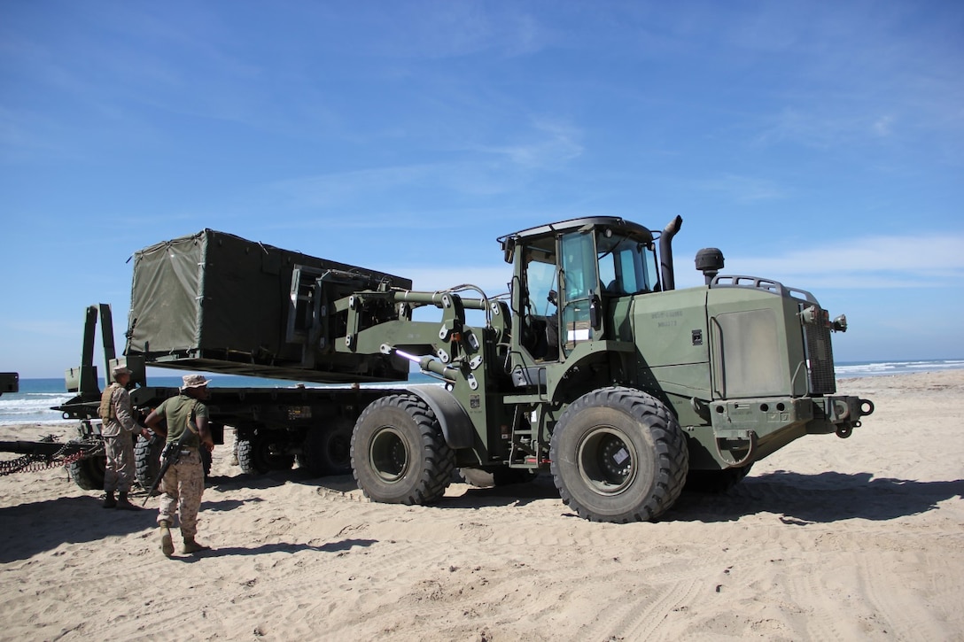 Marines with Marine Wing Support Squadron 373 unload components of the Tactical Water Purification System during exercise Pacific Horizon 2015 at Marine Corps Base Camp Pendleton, Calif., Oct. 22. PH 15 increases the ability of 1st Marine Expeditionary Brigade and Expeditionary Strike Group 3 to plan, communicate and conduct complex sea and shore based operations in response to natural disasters. (U.S. Marine Corps photo by Lance Cpl. Caitlin Bevel)