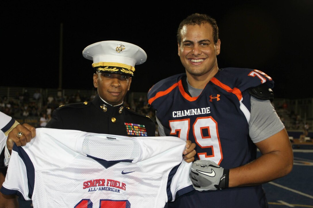 Maj. Dominique B. Neal, commanding officer of Recruiting Station Los
Angeles, presents Bar Milo with the 2015 Semper Fidelis All-American Bowl
jersey, Oct. 10, 2014. Milo is a senior at Chaminade College Preparatory in
Reseda, Calif. Milo was chosen from student athletes across the nation to
represent Team West during the 4th annual Semper Fi Bowl, which will be held at the Stub Hub Center in Carson, Calif. on Jan. 4, 2015. Milo, an offensive
tackle, was selected not only for his athletic capabilities, but also his
leadership qualities and strong characteristics upholding with the Marine Corps values.