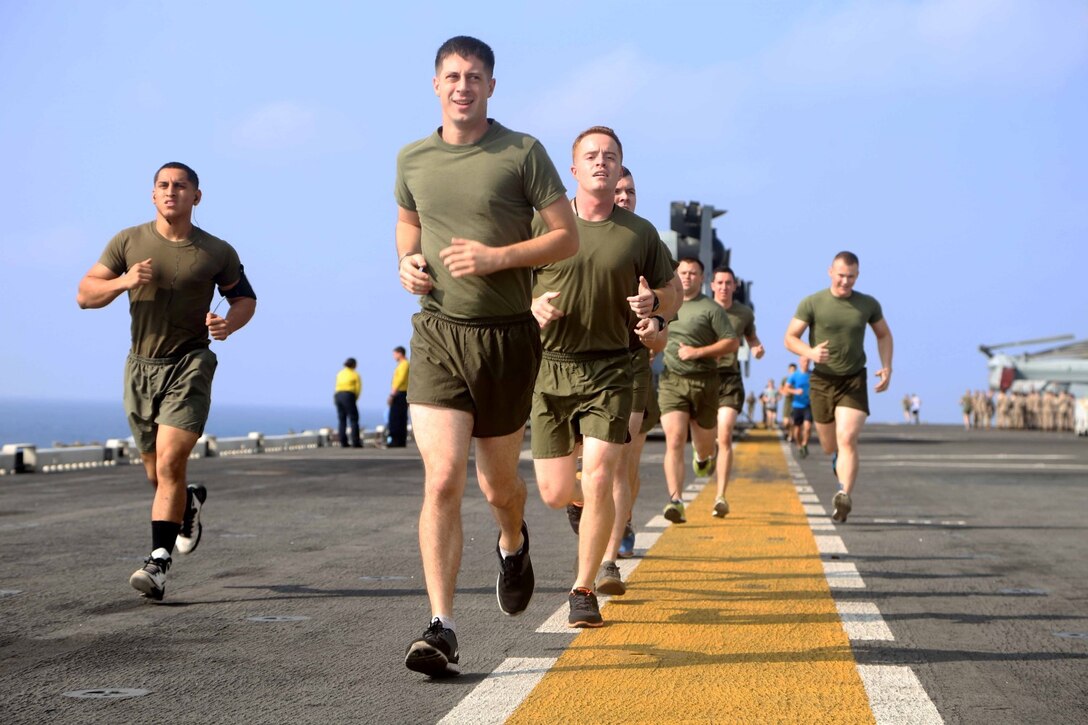 Marines with Charlie Battery, Battalion Landing Team 2nd Battalion, 1st Marines, 11th Marine Expeditionary Unit (MEU), conduct a group physical training session aboard the amphibious assault ship USS Makin Island (LHD 8), Oct. 19. The Makin Island Amphibious Ready Group (ARG) and the embarked 11th MEU are deployed in support of maritime security operations and theater security cooperation efforts in the U.S. 5th Fleet area of responsibility. (U.S. Marine Corps photos by Cpl. Demetrius Morgan/ Released) 