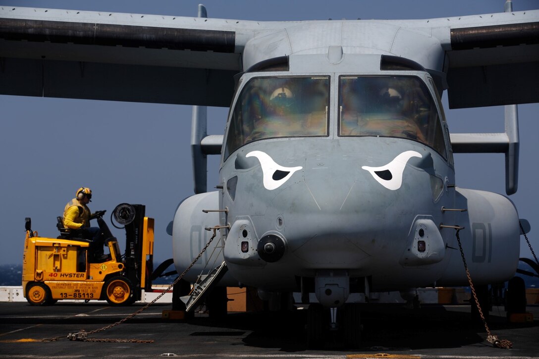 U.S. 5TH FLEET AREA OF RESPONSIBILITY (Oct. 20, 2014) A U.S. Navy sailor with the amphibious transport dock USS San Diego (LPD 22) uses a forklift to retrieve parts and supplies from a U.S. Marine Corps MV-22B Osprey with Marine Medium Tiltrotor Squadron 163 (Reinforced) [VMM-163 (REIN)], 11th Marine Expeditionary Unit (MEU), on the flight deck of San Diego, Oct. 20, 2014. The 11th MEU is embarked with the Makin Island Amphibious Ready Group and deployed to maintain regional security in the U.S. 5th Fleet area of responsibility. (U.S. Marine Corps photo by Cpl. Jonathan R. Waldman/Not Released)