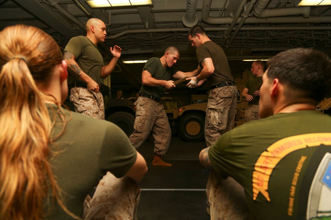 Marines with the 11th Marine Expeditionary Unit (MEU), practice techniques as part of a Marine Corps Martial Arts Program (MCMAP) “brown belt” training session aboard the amphibious assault ship USS Makin Island (LHD 8), Oct. 21. The Makin Island Amphibious Ready Group (ARG) and the embarked 11th MEU are deployed in support of maritime security operations and theater security cooperation efforts in the U.S. 5th Fleet area of responsibility. (U.S. Marine Corps photo by Cpl. Laura Y. Raga/Released)