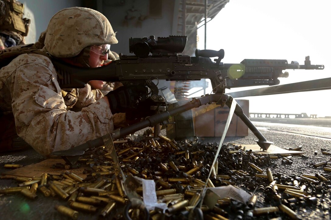 A machine gunner with Golf Company, Battalion Landing Team 2nd Battalion, 1st Marines, 11th Marine Expeditionary Unit (MEU), fires an M240B machinegun during a gunners qualification aboard the amphibious assault ship USS Makin Island (LHD 8), Oct. 19. The Makin Island Amphibious Ready Group (ARG) and the embarked 11th MEU are deployed in support of maritime security operations and theater security cooperation efforts in the U.S. 5th Fleet area of responsibility. (U.S. Marine Corps photo by Cpl. Laura Y. Raga/Released)