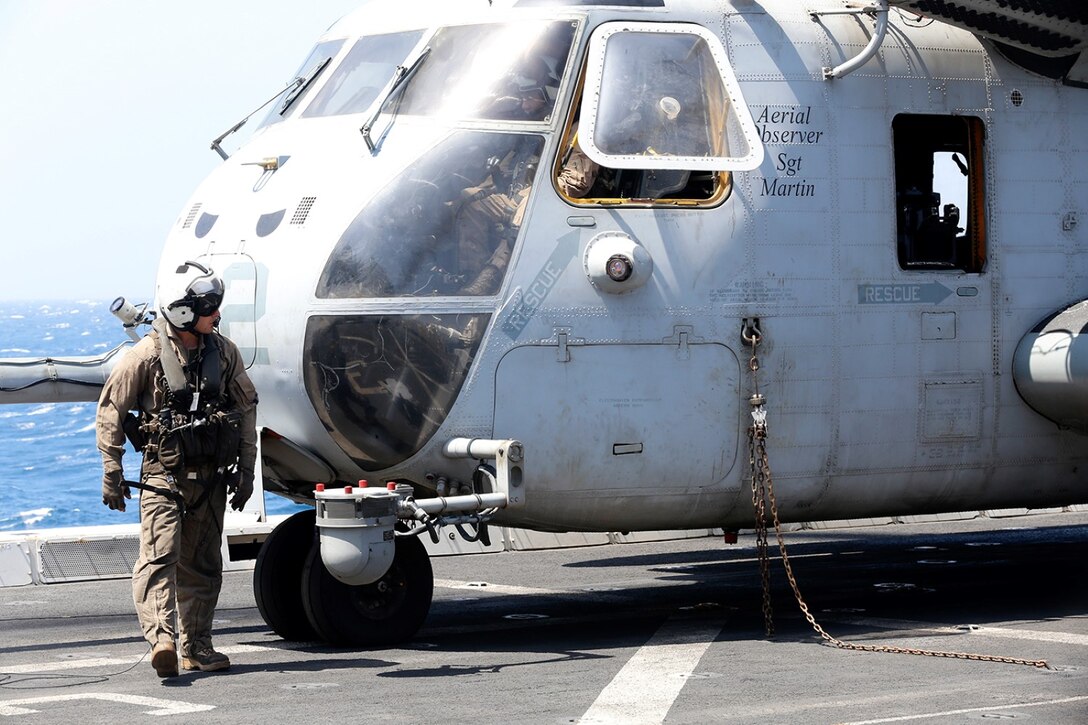 U.S. Marine Corps Cpl. Nicholas W. Solomon, a CH-53E Super Stallion crew chief with Marine Medium Tiltrotor Squadron 163 (Reinforced), 11th Marine Expeditionary Unit (MEU), and native of Piseataway, New Jersey, conducts a 360 degree preflight inspection of a CH-53E Super Stallion during flight operations aboard the amphibious transport dock ship USS San Diego (LPD 22), Oct. 20. The 11th MEU is a forward-deployed, flexible sea-based Marine Air-Ground Task Force embarked with the San Diego and the Makin Island Amphibious Ready Group in the U.S. 5th Fleet area of responsibility. (U.S. Marine Corps photos by Gunnery Sgt. Rome M. Lazarus/Not Released) 