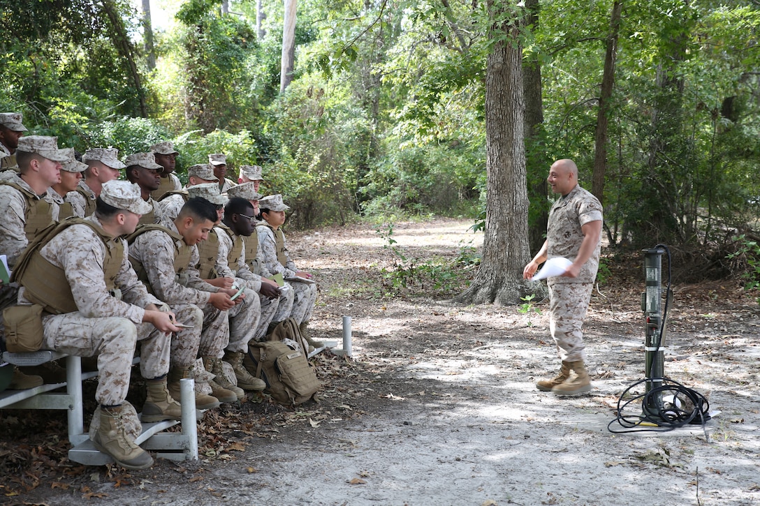 Staff Sgt. Jamil Alkattan, right, platoon sergeant, Company A, Ground Combat Element Integrated Task Force, instructs a class on the AT4 weapon system outside of the indoor simulated marksmanship trainer aboard Marine Corps Base Camp Lejeune, North Carolina,, Oct. 22, 2014. The Co. A PRP is made up of male and female volunteers from numerous military occupational specialties who have had no additional infantry-specific training since Marine Combat Training. From October 2014 to July 2015, the Ground Combat Element Integrated Task Force will conduct individual and collective skills training in designated combat arms occupational specialties in order to facilitate the standards based assessment of the physical performance of Marines in a simulated operating environment performing specific ground combat arms tasks. (U.S. Marine Corps photo by Cpl. Paul S. Martinez/Released)