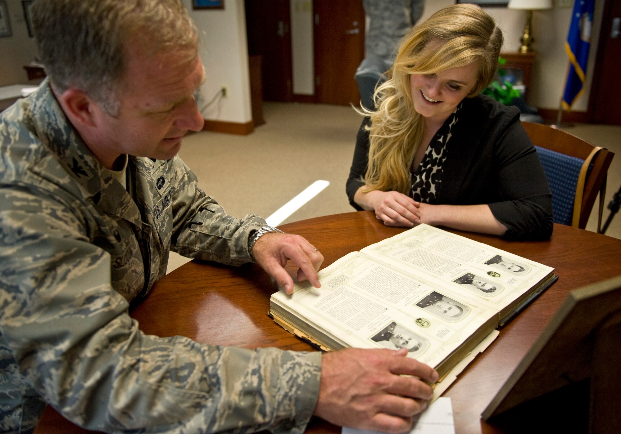 Col. Mark Slocum looks at the yearbook of Seymour Johnson Air Force Base’s namesake, Navy Lt. Seymour Johnson, with Jaime Thompson Oct. 17, 2014, at Seymour Johnson AFB, N.C. Slocum is the 4th Fighter Wing commander and Thompson is Seymour Johnson’s great-granddaughter. During her visit, Thompson familiarized herself with her great-grandfather’s and the base’s history. For the first, she was able to discover the full legacy left behind by her great-grandfather. (U.S. Air Force photo/Airman 1st Class Aaron Jenne) 