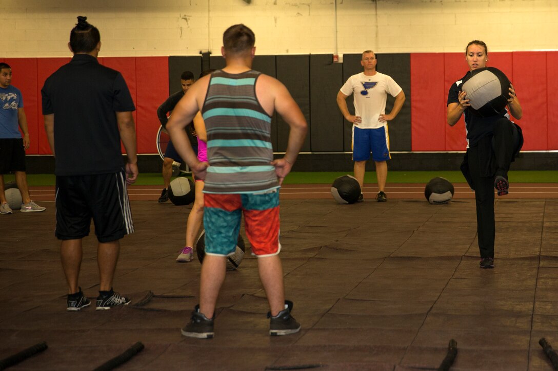 Riana Rohmann, level-three HITT instructor and fitness specialist with the installation’s gymnasiums, demonstrates an exercise during a workout at the High Intensity Tactical Training Center aboard Marine Corps Air Station Miramar, Calif., Oct. 22. Rohmann and her fellow instructors push Marines and challenge their bodies in a safe way.