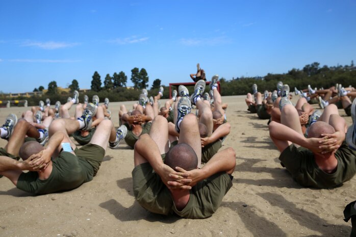 Recruits of India Company, 3rd Recruit Training Battalion, perform bicycle crunches during the Stregth and Endurance Course at Marine Corps Recruit Depot San Diego, Oct. 8. The bicycle crunches were a warm-up prior to the Strength and Endurance Course.