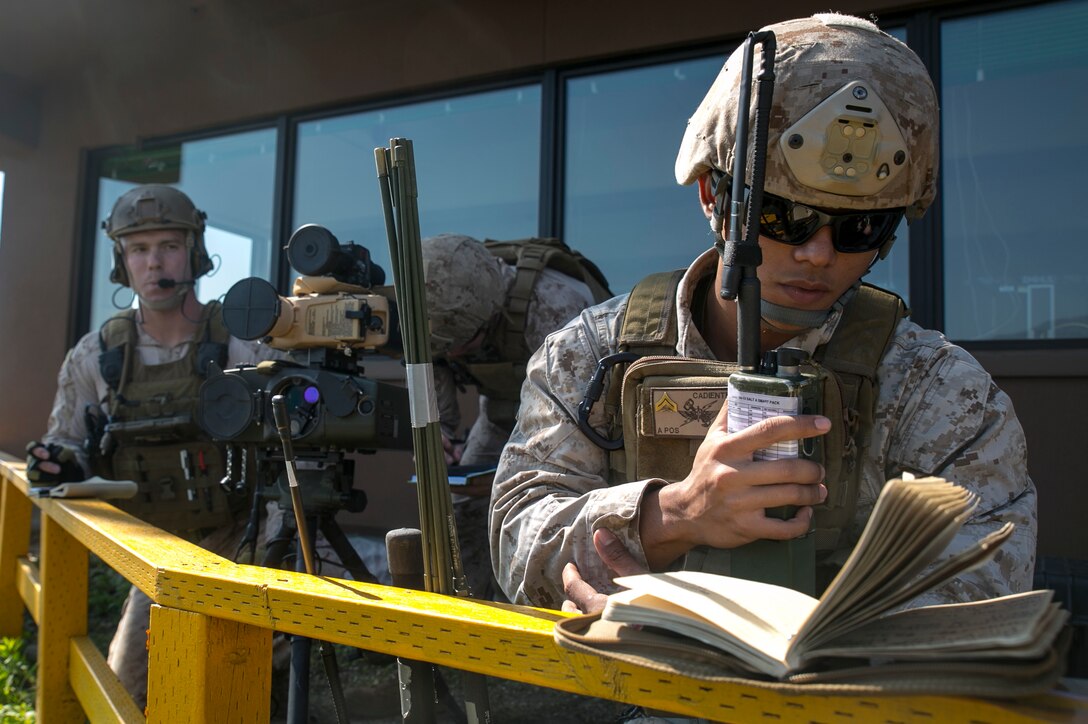 Cpl. Viktor Cadiente, right, calls for close air support Oct. 8 at Rodriguez Live Fire Complex during Korean Marine Exchange Program 14-13. KMEP familiarizes U.S. Marines with the Korean Peninsula and builds upon an existing strong relationship between Republic of Korea and U.S. Marines. Cadiente is from Honolulu, Hawaii, and is a joint fires observer with 5th Air Naval Gunfire Liaison Company, III Marine Expeditionary Force Headquarters Group, III MEF. 