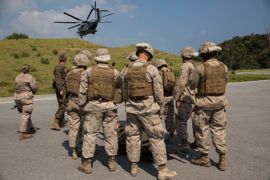Petty Officer 2nd Class Joshua Rogers, right, from Martin, Georgia, responds to a simulated wounded enemy during a medical evacuation drill Sept. 30 at the Kin Blue Training Area. Rogers was part of the quick reaction force that gained control over two mock enemy positions. Marines and sailors are taught to provide first aid to enemy personnel as well as their own forces. Rogers is with 3rd Medical Battalion, 3rd Marine Logistics Group, III Marine Expeditionary Force. (U.S. Marine Corps photo by Lance Cpl. Rebecca Elmy/Released)