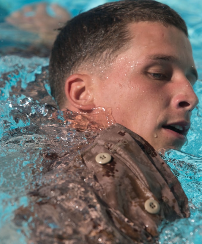 Sgt. Christopher Rateau-Holbach, from Fulton, Mississippi, swims laps with fins during a scout swimmers course Oct. 21 at the Camp Hansen Aquatics Center. The scout swimmers course provides the Marine Corps with amphibious capabilities and Marines become proficient at long-distance swimming with fins. Rateau-Holbach is a student with Expeditionary Operations Training Group, III Marine Expeditionary Force Headquarters Group, III MEF. 