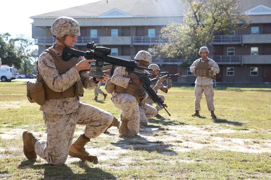Cpl. Erich Jurgensen, left, motor vehicle operator, Provisional Rifle Platoon, Company A, Ground Combat Element Integrated Task Force, conducts a speed reload during fire and maneuver drills executed at the company’s barracks, Oct. 22, 2014. The Co. A PRP is made up of male and female volunteers from numerous military occupational specialties who have had no additional infantry-specific training since Marine Combat Training. From October 2014 to July 2015, the Ground Combat Element Integrated Task Force will conduct individual and collective skills training in designated combat arms occupational specialties in order to facilitate the standards based assessment of the physical performance of Marines in a simulated operating environment performing specific ground combat arms tasks. 