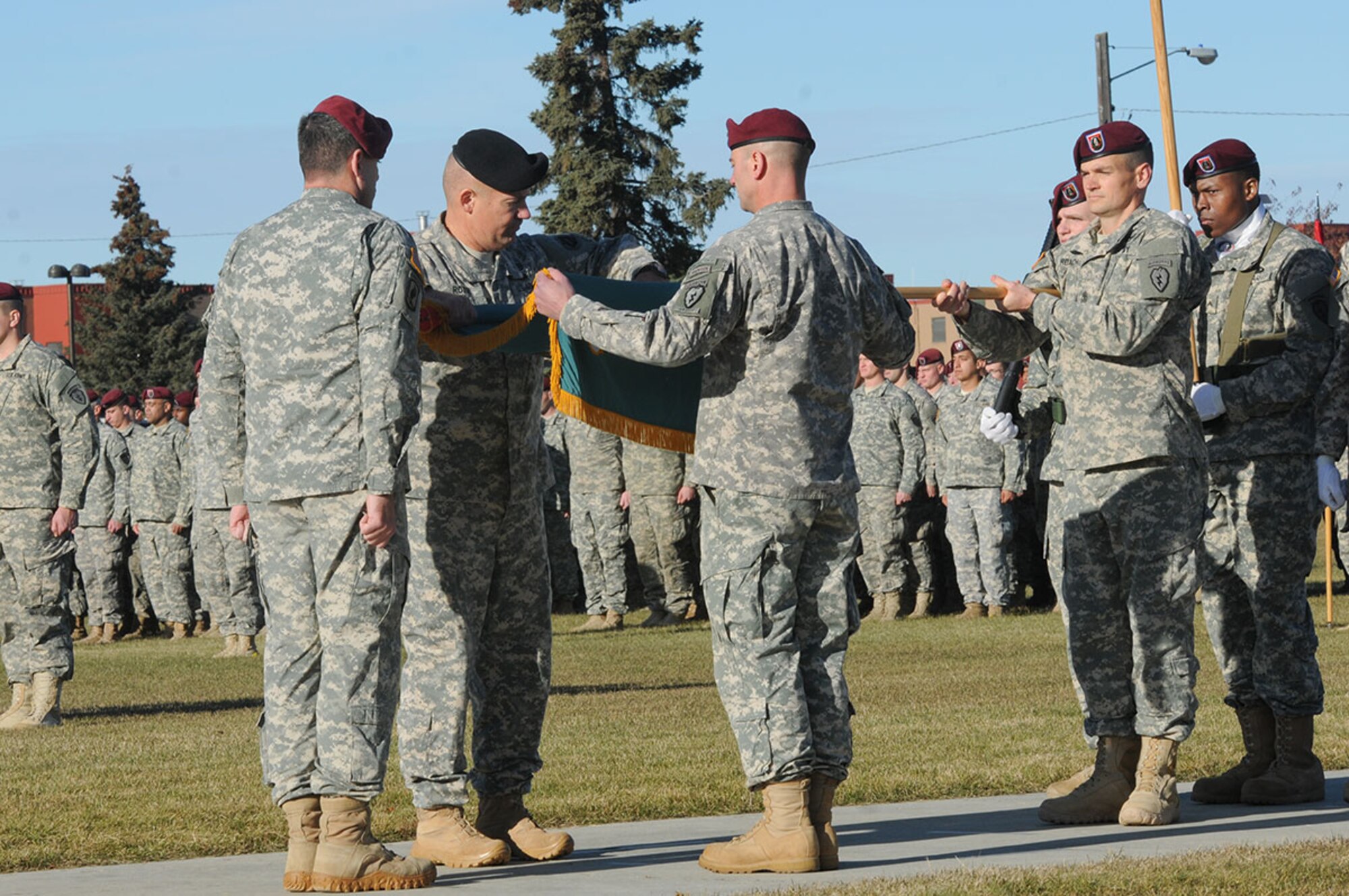 The original commander of the 425th Brigade Special Troops Battalion (Airborne), 4th Infantry Brigade Combat Team (Airborne), 25th Infantry Division, Col. Tom Roth (black beret), who is now with U.S. Army Alaska, and the last commander of the 425th, Lt. Col. Kevin Perera, roll up the battalion’s colors to case them, formally inactivating the battalion during the unit’s inactivation ceremony Oct. 17, 2014 at Joint Base Elmendorf-Richardson, Alaska. The 6th Brigade Engineer Battalion (Airborne) will assume the duties of the inactivated Warrior Battalion for the Spartan Brigade. The 6th BEB brings increased engineer command structure and presence while maintaining the readiness provided by the outgoing 425th. (U.S. Army photo by Sgt. 1st Class Jeffrey Smith)