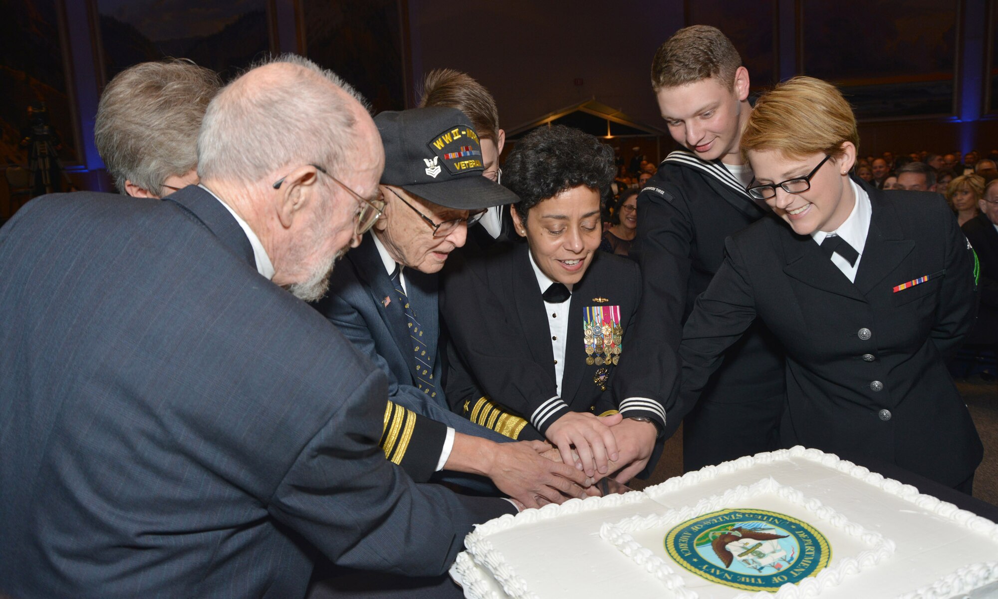 Vice Chief of Naval Operations Adm. Michelle Howard along with two of the oldest prior service military members and the most junior Sailors in attendance at the 2014 Navy Ball cuts the Navy Birthday cake during the ceremony held at the National Cowboy and Western Heritage Museum in Oklahoma City.  This year’s event spotlighted the service of those who serve the military and gave Sailors a chance to thank local community leaders for the support they receive on a daily basis. (U.S. Navy photo by Chief Petty Officer Chris Delano)