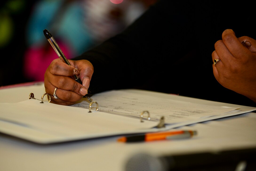 Janae Johnson, Operation Rising Star judge, scores the competitors during the first round of the competition at Fort Eustis, Va., Oct. 22, 2014. The judges controlled half of the vote that allowed a competitor to make it to the next round, if chosen as the overall winner the contestant will receive $500 and move on to the Army-wide finals. (U.S. Air Force photo by Airman 1st Class Kimberly Nagle/Released)