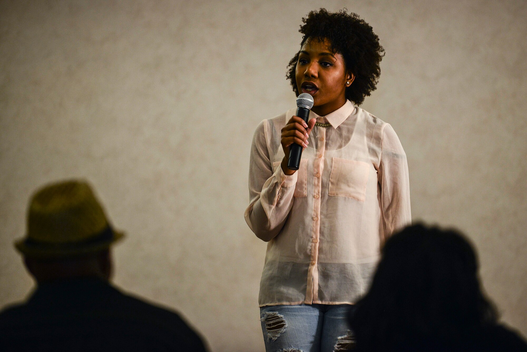 U.S. Army Spc. Alicia Elam, Dental Activity dental specialist, sings during the first round of Operation Rising Star at Fort Eustis, Va., Oct. 22, 2014. Elam was one of three contestants that made it to the next round of the competition. (U.S. Air Force photo by Airman 1st Class Kimberly Nagle/Released)