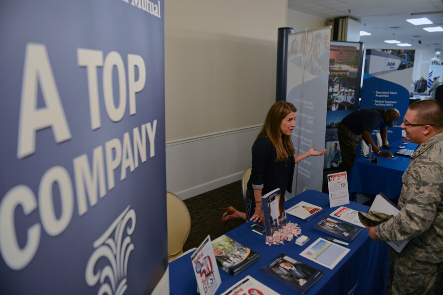 Amy Caskey, Northern Mutual director of marketing, speaks with a military member about possible job options during a job and resource fair at Shaw Air Force Base, S.C., Oct. 23, 2014. The 20th Force Support Squadron job and resource fair gave Team Shaw and their families potential career opportunities from approximately 50 business representatives. (U.S. Air Force photo by Senior Airman Tabatha Zarrella/Released)