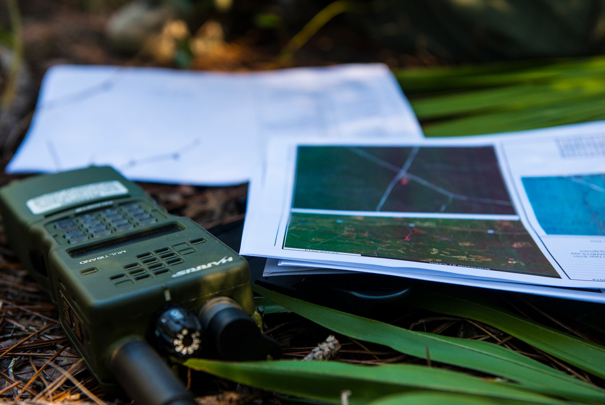 A radio and map rest on the ground during a combat search and rescue task force exercise Oct. 22, 2014, in Homerville, Ga. A simulated survivor used the radio and map to assist in being rescued by the 41st Rescue Squadron. (U.S. Air Force Airman 1st Class Ceaira Tinsley/Released)