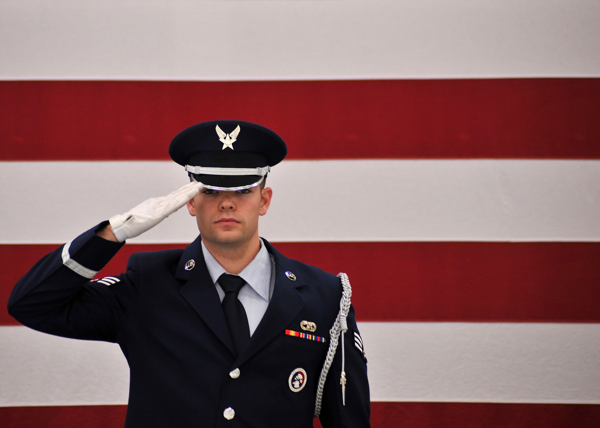 Senior Airman Syler Feldman, Grand Forks Air Force Base Honor Guard ceremonial guardsman, renders a salute to a folded U.S. flag during a two-man flag folding practice session Oct. 22, 2014, inside the honor guard building on Grand Forks Air Force Base, N.D. The 22-year-old from San Diego, Calif., was named the Grand Forks AFB Warrior of the Week for the fourth week of October 2014. (U.S. Air Force photo/Senior Airman Xavier Navarro) 