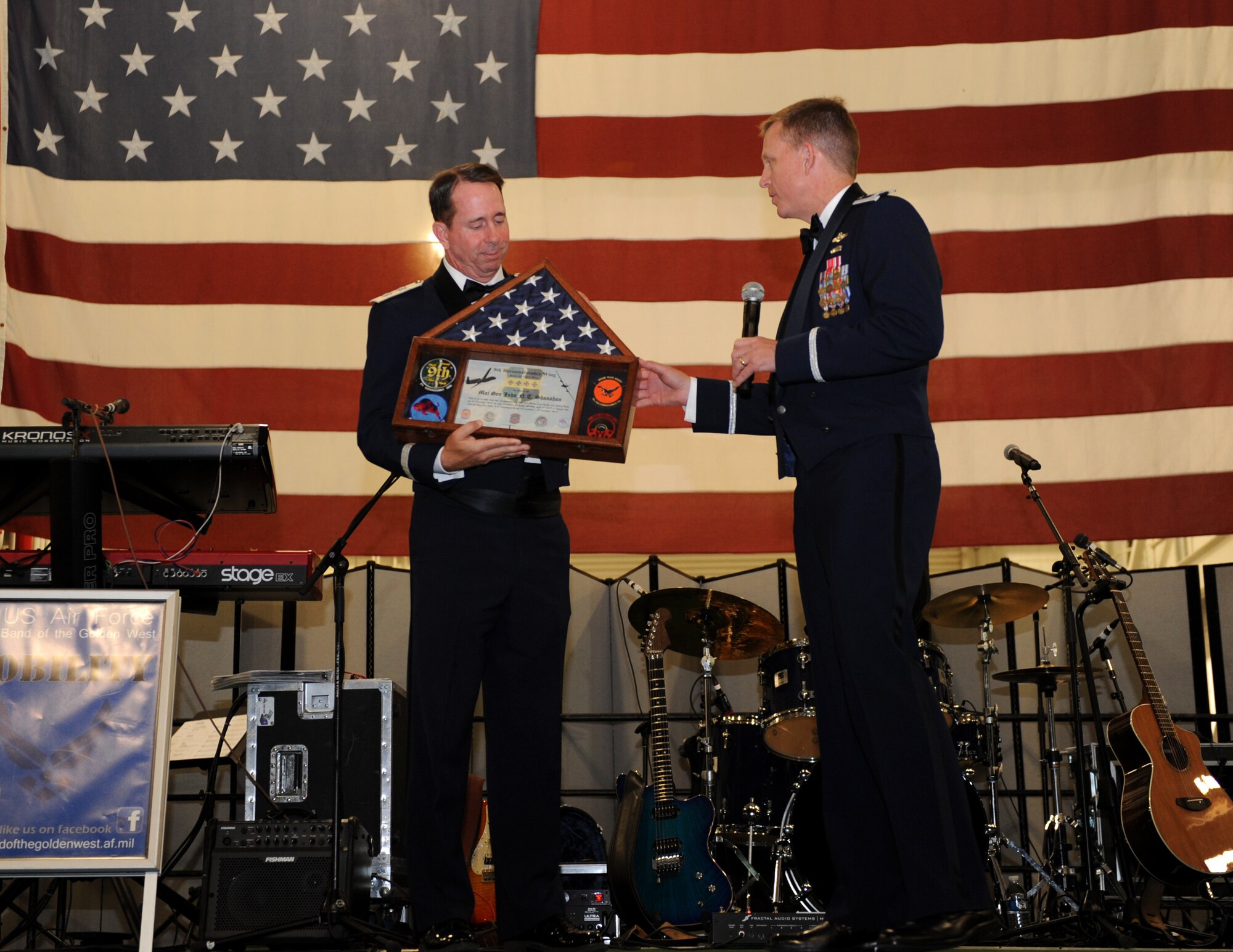 Maj. Gen. John Shanahan, 25th Air Force commander (left), accepts a shadow box from Col. Douglas Lee, 9th Reconnaissance Wing commander, during Beale’s Air Force Ball held on Beale Air Force Base, Calif., Oct. 18, 2014. Shanahan completed a five-day tour of Beale’s missions. (U.S. Air Force photo by Staff Sgt. Robert M. Trujillo/Released)