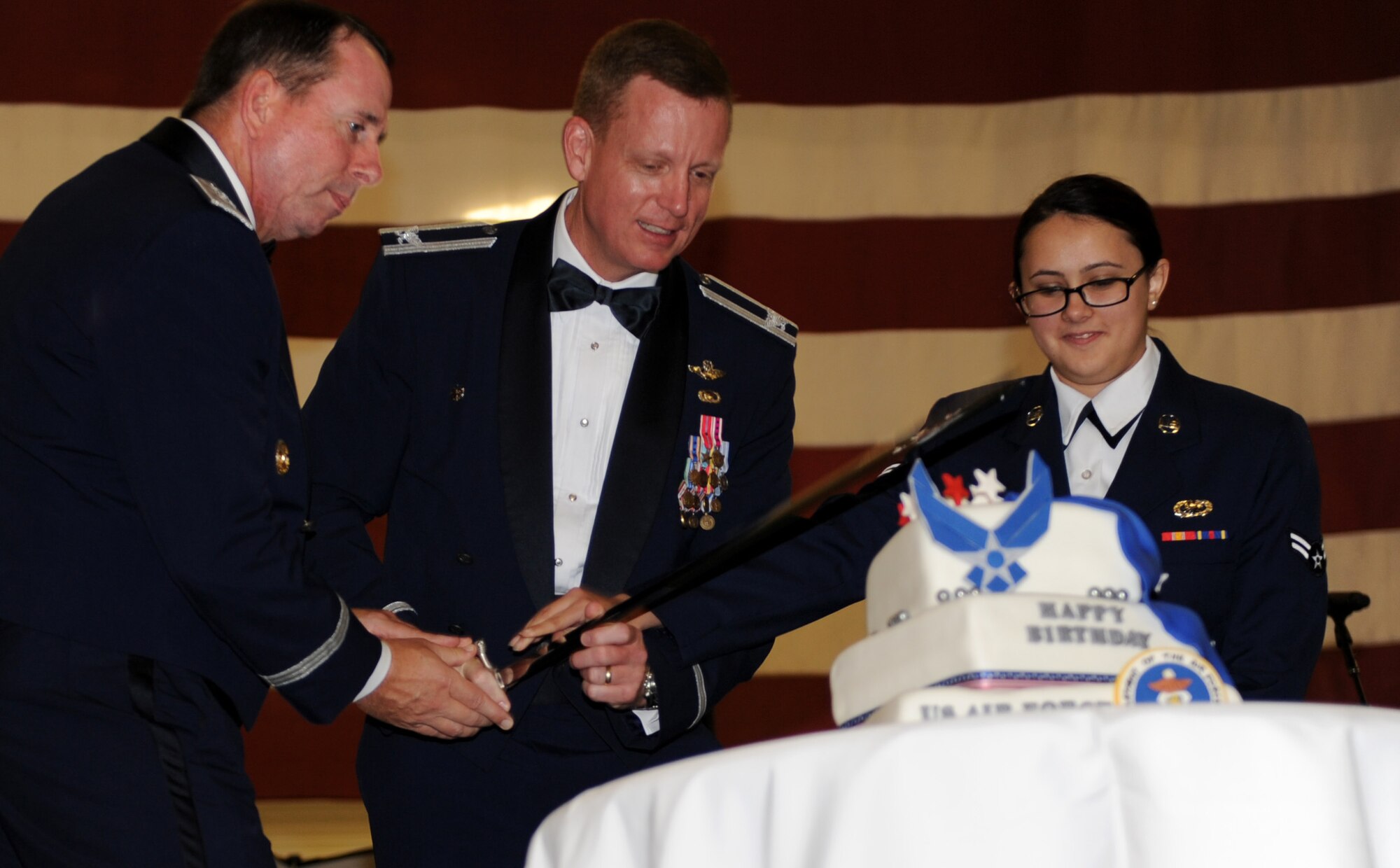 Maj. Gen. John Shanahan, 25th Air Force commander (left), Col. Douglas Lee, 9th Reconnaissance Wing commander, and Airman 1st Class Samantha Campbell, cut a cake during Beale’s Air Force Ball held on Beale Air Force Base, Calif., Oct. 18, 2014. It’s an Air Force tradition to have the most junior and senior-ranking Airmen to cut a ceremonial cake. (U.S. Air Force photo by Staff Sgt. Robert M. Trujillo/Released)