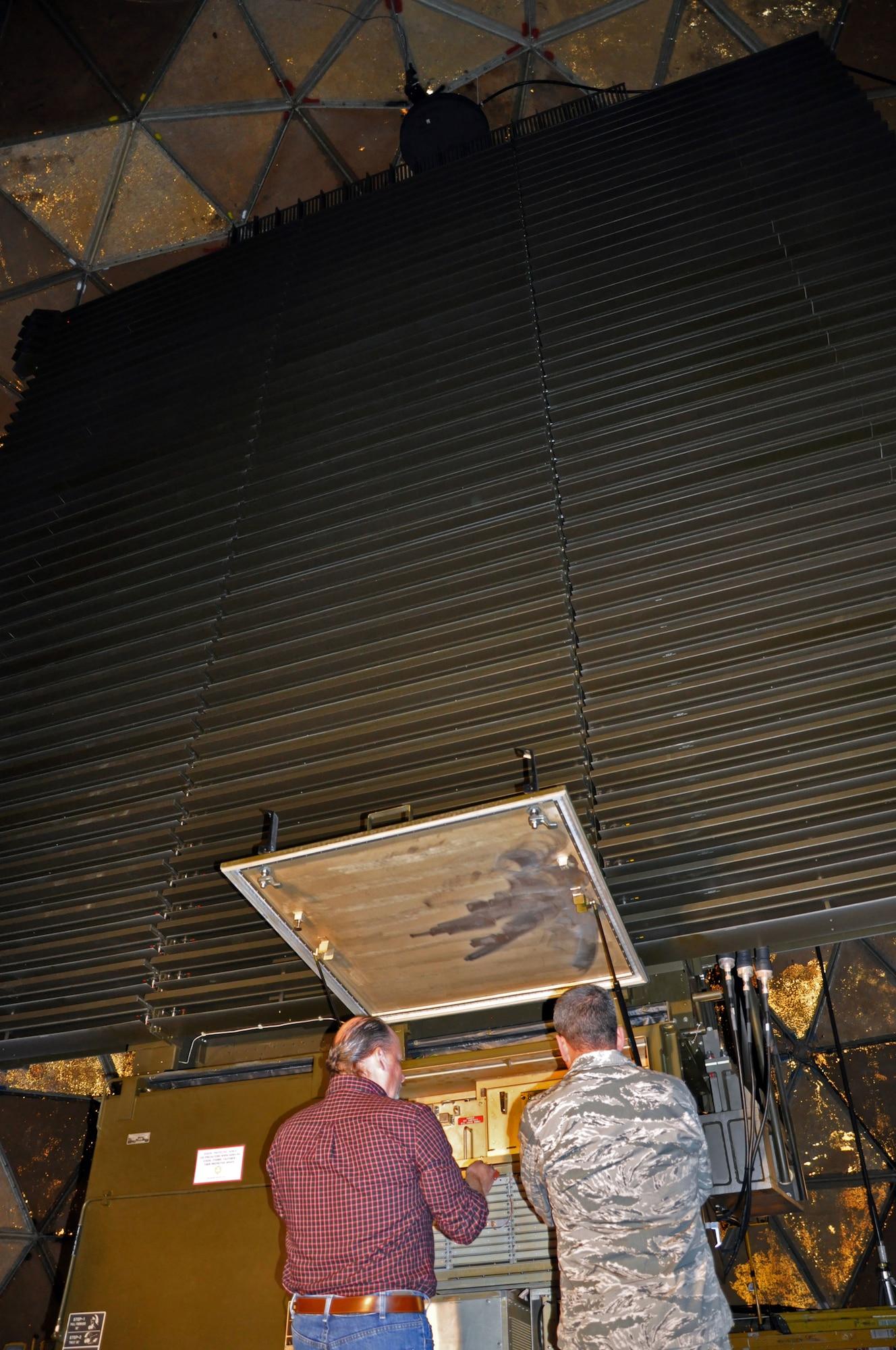U.S. Air Force Lt. Gen. Russ Handy, 11th Air Force commander, learns about the Long-Range Air Surveillance Radar System at Tin City Long Range Radar Site, Alaska, October 1, 2014 housed inside a geodesic dome resembling a golf ball. The Tin City LRRS, along with 14 additional radar sites across the rugged terrain of Alaska, scan the airspace above 24 hours a day, seven days a week, 365 days per year, searching for potential threats. Together with the men and women of the Pacific Air Forces Regional Support Center at Joint Base Elmendorf-Richardson, Alaska, this team makes up the unsung heroes that protect our nation’s northern and western borders. (U.S. Air Force photo/Capt. Anastasia Wasem)