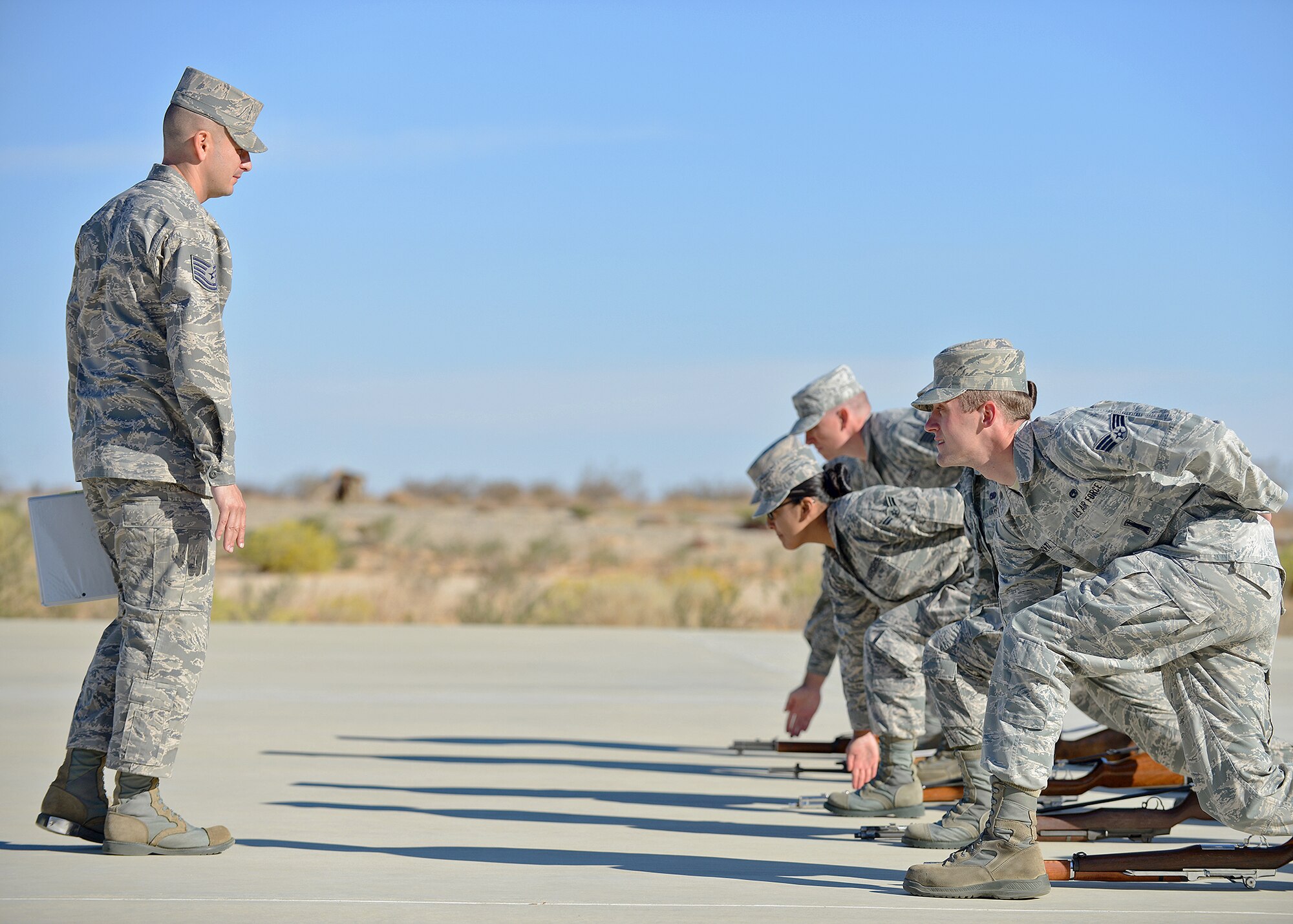 Tech. Sgt. Doumit Elias (left), U.S. Air Force Honor Guard ceremonial guardsman, explains how to recover a rifle during Firing Party training Oct. 21 on the Airman Leadership School Drill Pad. More than 22 Blue Eagles Honor Guard members are undergoing an eight-day training course in order to perform military ceremonial duties throughout the Southern California area. Each year, members from the United States Air Force Honor Guard at Bolling Air Force Base, Washington, D.C., are selected as instructors to travel to various bases and provide training in an intense, week-long course. (U.S. Air Force photo by Jet Fabara)