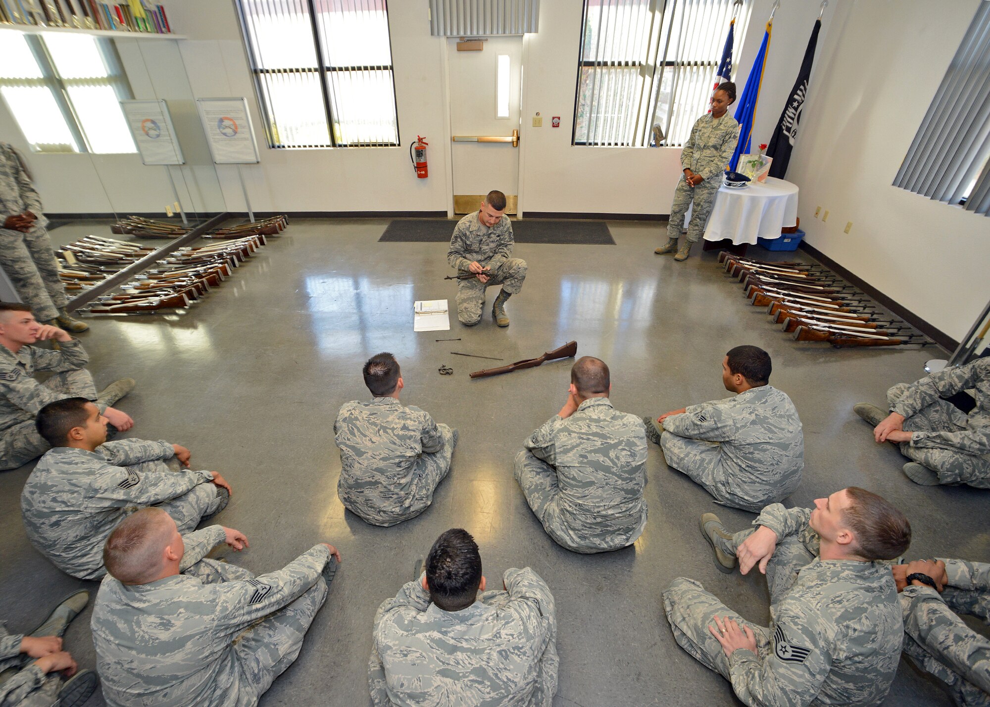 Tech. Sgt. Doumit Elias (top center), U.S. Air Force Honor Guard ceremonial guardsman, demonstrates how to disassemble a rifle Oct. 21 during an eight-day training course for more than 22 Blue Eagles Honor Guard members who will go on to perform military ceremonial duties throughout the Southern California area. Each year, members from the United States Air Force Honor Guard at Bolling Air Force Base, Washington, D.C., are selected as instructors to travel to various bases and provide training in an intense, week-long course. (U.S. Air Force photo by Jet Fabara)