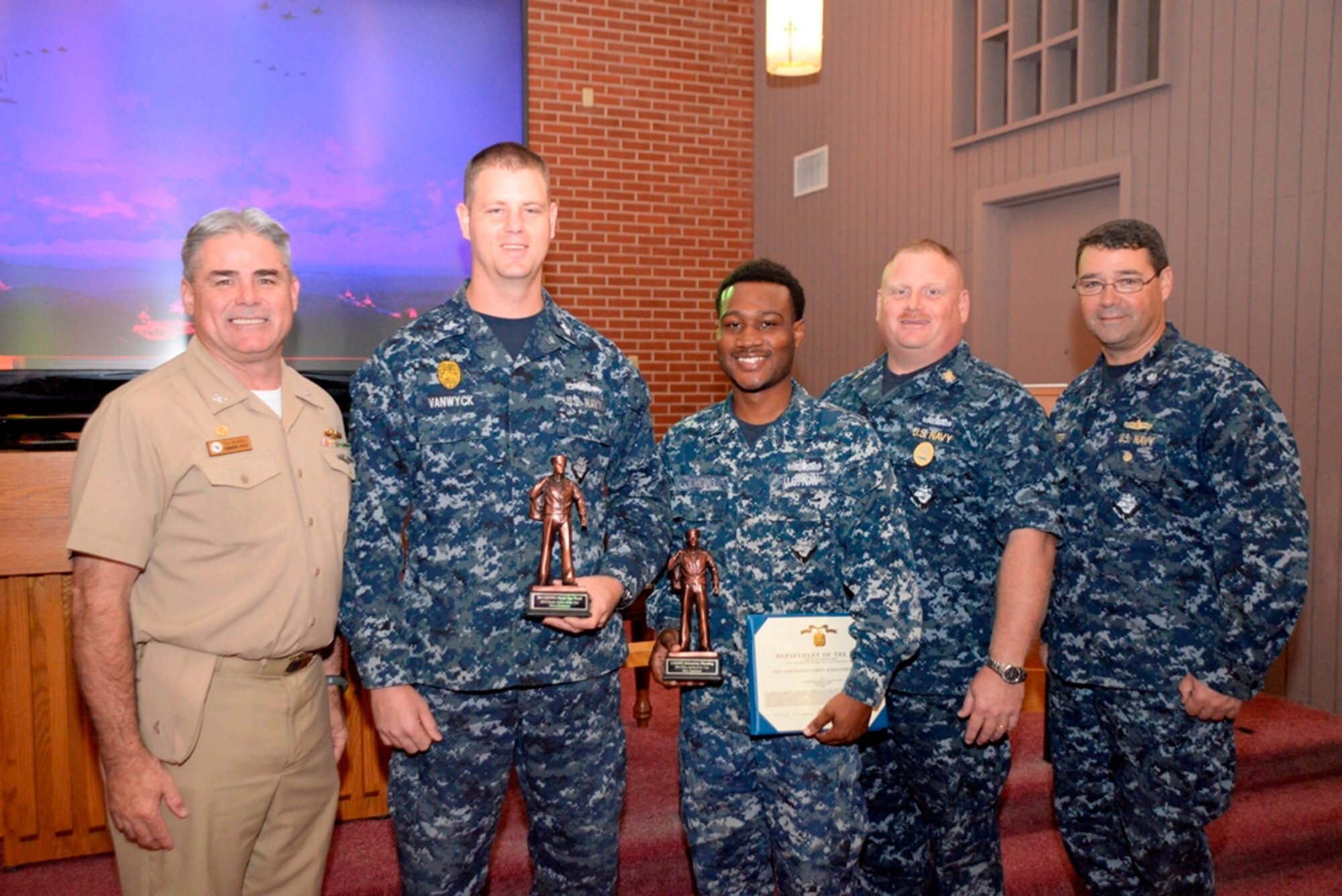 Naval Support Activity held an awards ceremony Oct. 23, 2014, at the Good Shepherd Chapel on Joint Base Charleston, S.C. During the ceremony, Petty Officer 1st Class Mark Vanwyck (second from left) was named the commands Sailor of the Year for fiscal year 2014, and Petty Officer 3rd Class Delmetrius Blanding (third from left) was named Blue Jacket of the Year for fiscal year 2014. The Junior Sailor of the Year was Petty Officer 2nd Class Brian Cobb who was not available for this photo. Congratulating the Sailors of the Year are Capt. Timothy Sparks, JB Charleston deputy commander and NSA commanding officer, Master Chief Petty Officer Joseph Gardner, NSA command master chief and Cmdr. David Tarwater, NSA executive officer. (U.S. Air Force photo/Eric Sesit)