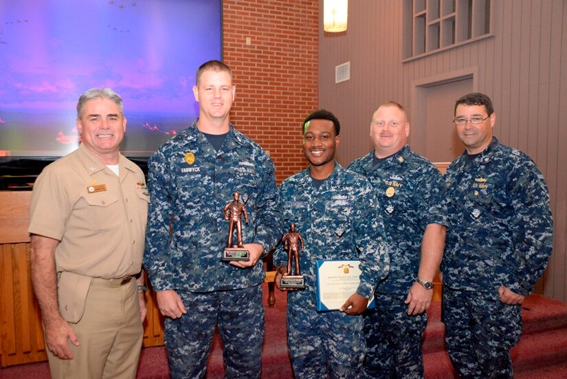 Naval Support Activity held an awards ceremony Oct. 23, 2014, at the Good Shepherd Chapel on Joint Base Charleston, S.C. During the ceremony, Petty Officer 1st Class Mark Vanwyck (second from left) was named the commands Sailor of the Year for fiscal year 2014, and Petty Officer 3rd Class Delmetrius Blanding (third from left) was named Blue Jacket of the Year for fiscal year 2014. The Junior Sailor of the Year was Petty Officer 2nd Class Brian Cobb who was not available for this photo. Congratulating the Sailors of the Year are Capt. Timothy Sparks, JB Charleston deputy commander and NSA commanding officer, Master Chief Petty Officer Joseph Gardner, NSA command master chief and Cmdr. David Tarwater, NSA executive officer. (U.S. Air Force photo/Eric Sesit)