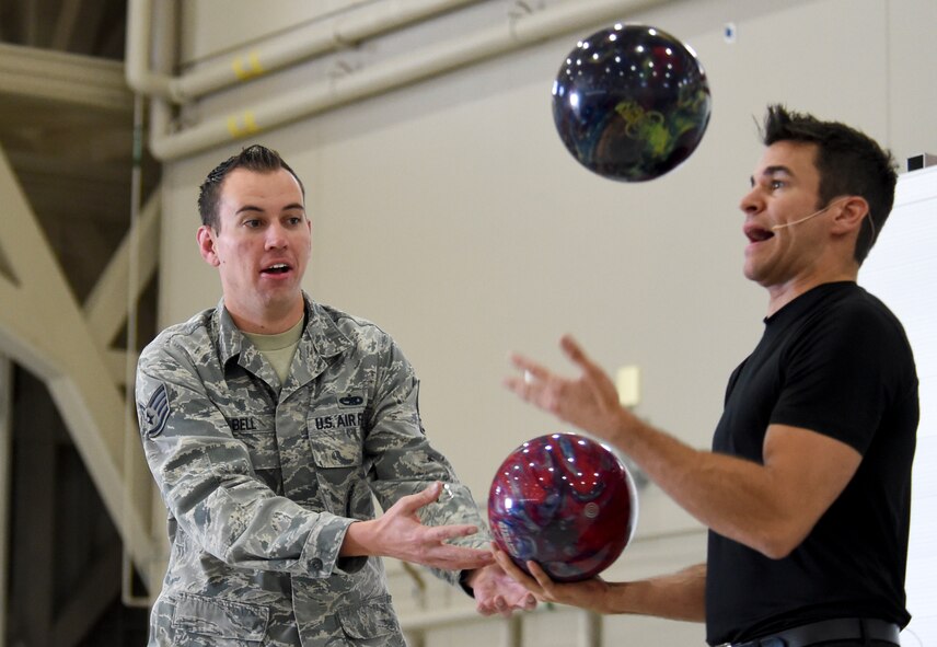 Staff Sgt. Andrew Bell, 432nd Aircraft Maintenance Squadron weapons load crew member, reacts when juggler and comedian, Jeff Civillico, pretends to drop a bowling ball during a performance at Creech Air Force Base, Nevada, Oct. 17, 2014. Several audience members were included in most parts of the juggling and comedy routine. (U.S. Air Force photo by Tech. Sgt. Shad Eidson/Released)