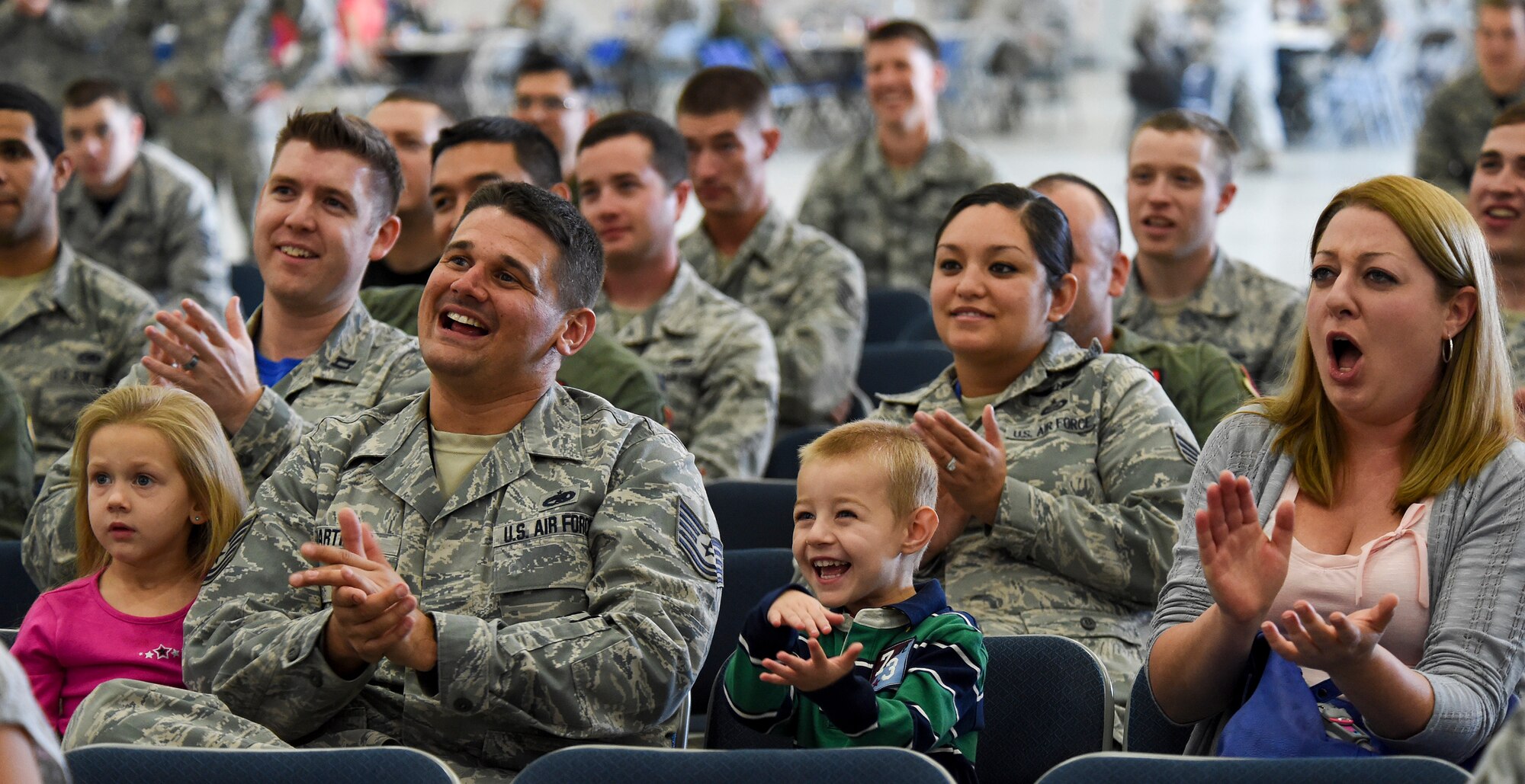 Airmen and their families clap for juggler and comedian, Jeff Civillico, during his performance at Creech Air Force Base, Nevada, Oct. 17, 2014. The entertainment and food event was the latest USO-sponsored show to lift the spirits of America’s troops and their families, which the USO has provided since its creation in 1941. (U.S. Air Force photo by Tech. Sgt. Shad Eidson/Released)