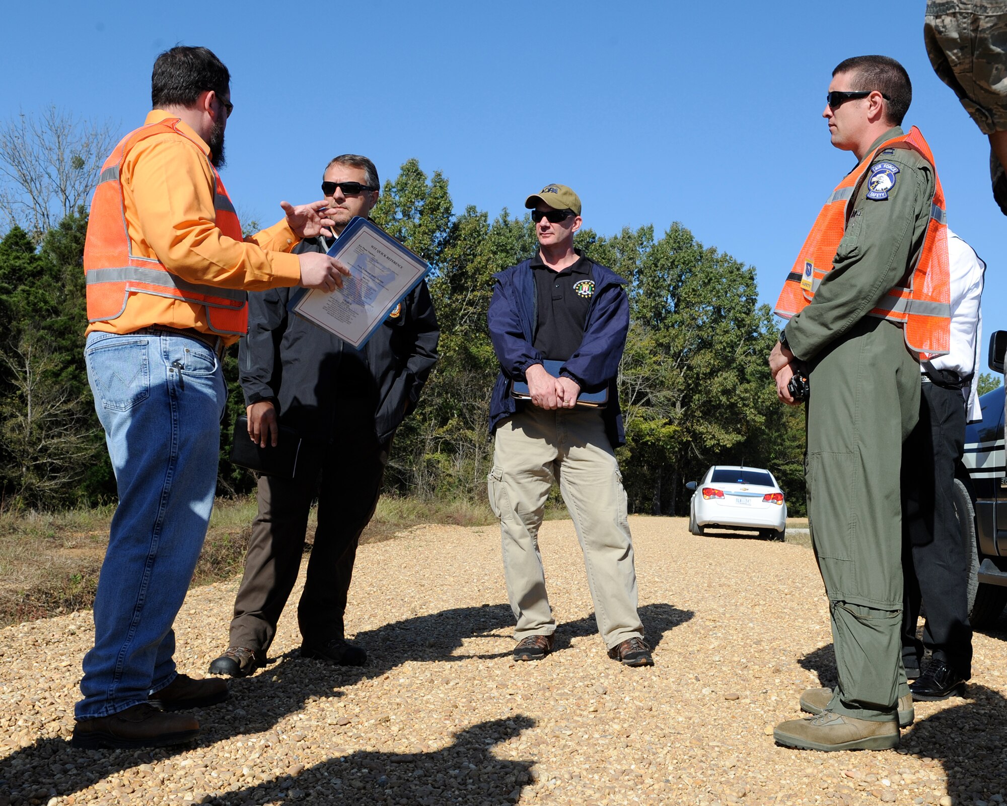 John Lindell, 14th Flying Training Wing Ground Safety Manager, talks with Columbus FBI Agents as Capt. Erik Goff, 14th FTW Flight Safety Officer, observes during a Golden Triangle Regional Airport disaster preparedness exercise Oct. 21 at the airport. The triennial exercise is a joint exercise among GTR Airport, Golden Triangle area emergency responders and Columbus Air Force Base units. (U.S. Air Force photo/Elizabeth Owens)