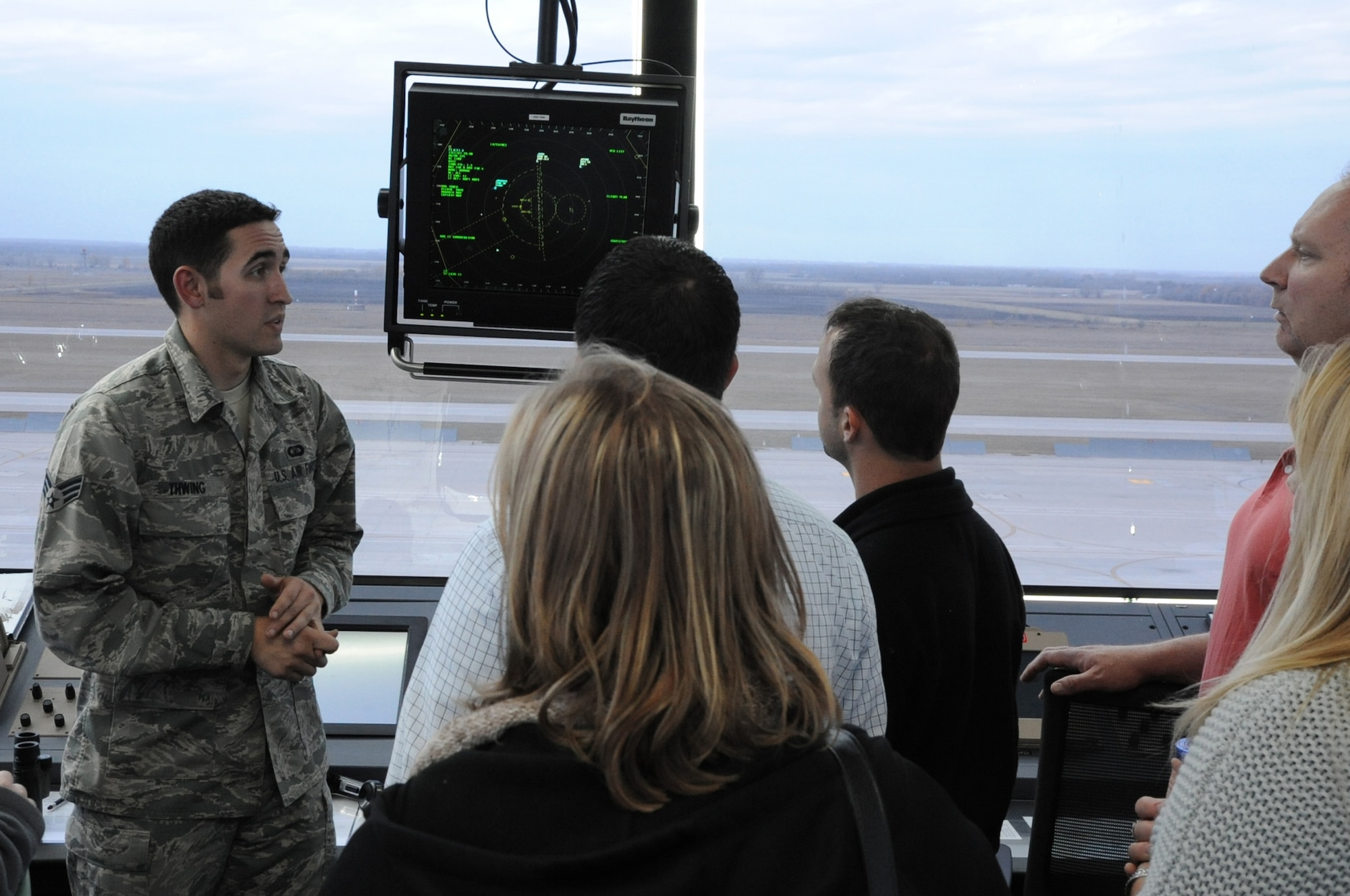 Senior Airman Kyle Thwing, 319th Operations Support Squadrdon air traffic controller, speaks to members of the Grand Forks Chamber of Commerce Annual Leadership Seminar about daily operations in the Air Traffic Control tower on Grand Forks Air Force Base, N.D., Oct. 22, 2014. More than 40 local citizens and businesspeople spent the day touring various facilities on the base. (U.S. Air Force photo/Staff Sgt. David Dobrydney)
