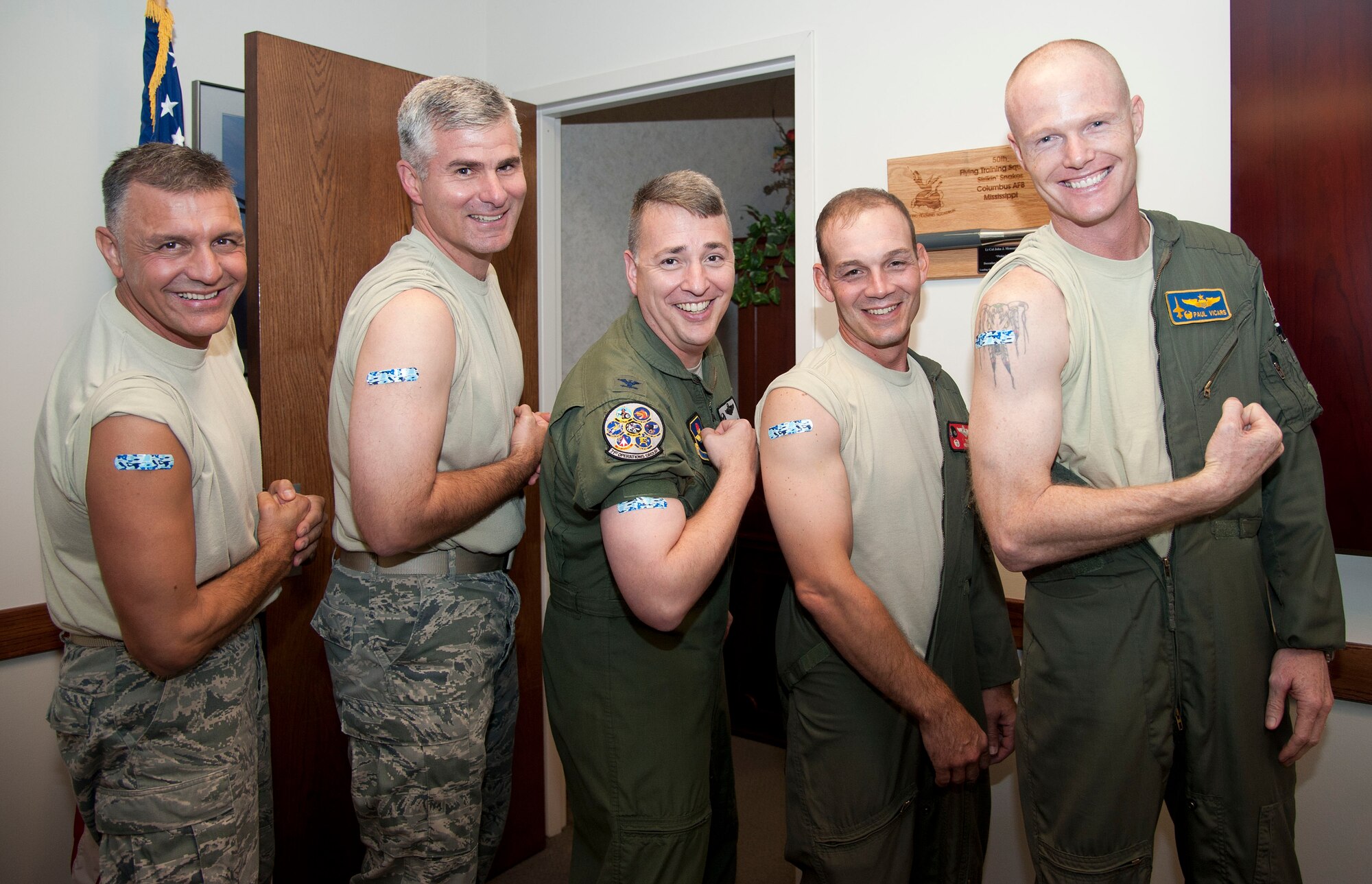 VANCE AIR FORCE BASE, Okla. – (Left to right) Chief Master Sgt. Peter Speen, Col. John Menozzi, Col. John Cinnamon, Lt. Col. Troy Henderson and Lt. Col. Paul Vicars show off their adhesive bandages after receiving their influenza vaccinations.  Flu shots and Flumist are now available to all active duty, Guard and Reserve military members, dependents and retirees at the 71st Medical Group immunizations office. (U.S. Air Force photo/Staff Sgt. Nancy Falcon)