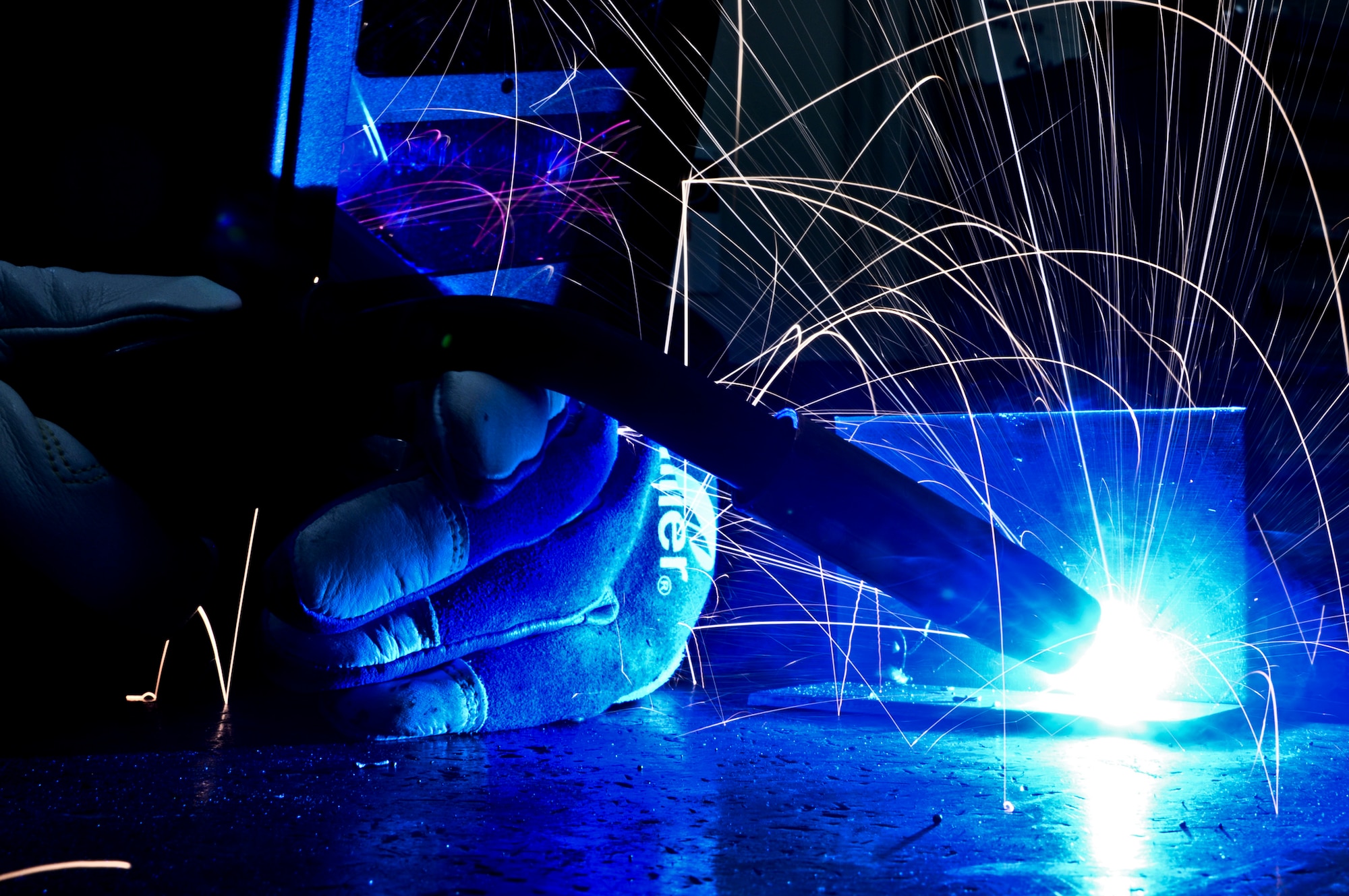 Airman 1st Class Brandon Kays, 911th Maintenance Squadron metals technology specialist, mig welds a T-joint for training at the Pittsburgh International Airport Air Reserve Station, Oct. 4, 2014. Metals technology specialists must mig weld once every six months and tig weld seven different types of metal to comply with training standards. (U.S. Air Force photo by Senior Airman Joshua J. Seybert)