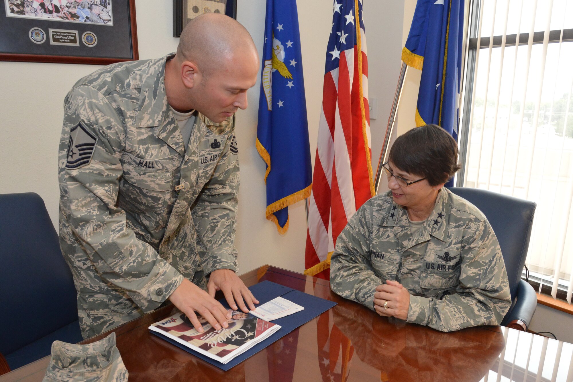 Master Sgt. Robert Hall, Combined Federal Campaign installation project officer, discusses the campaign and the various charities it supports with Maj. Gen. Sandra Finan, Air Force Nuclear Weapons Center commander. Team Kirtland has raised more than $91,000 during the campaign, which is set to run through Nov. 4. The base has a goal of raising $350,000 this year. (Photo by Ken Moore)